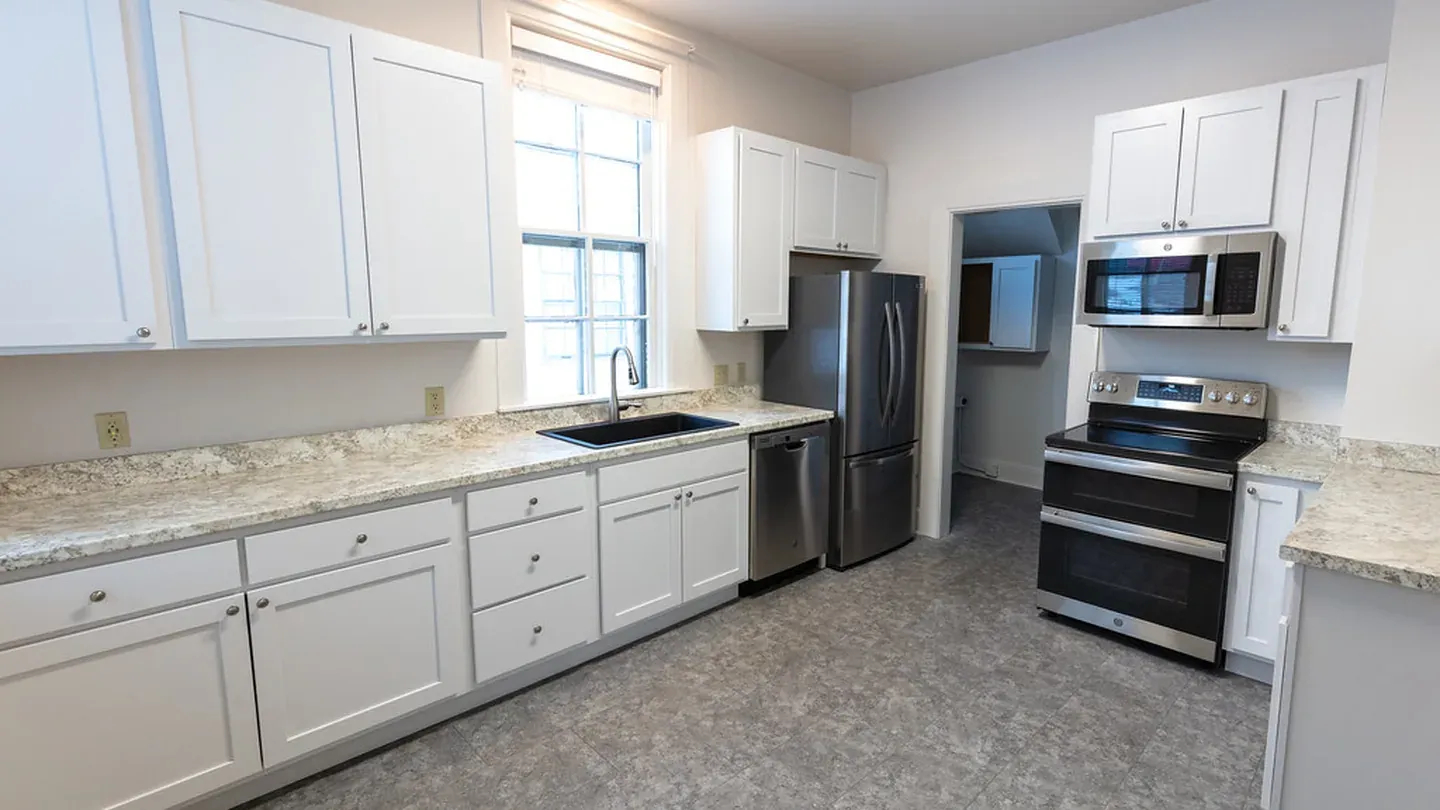 A white galley kitchen with two facing working walls